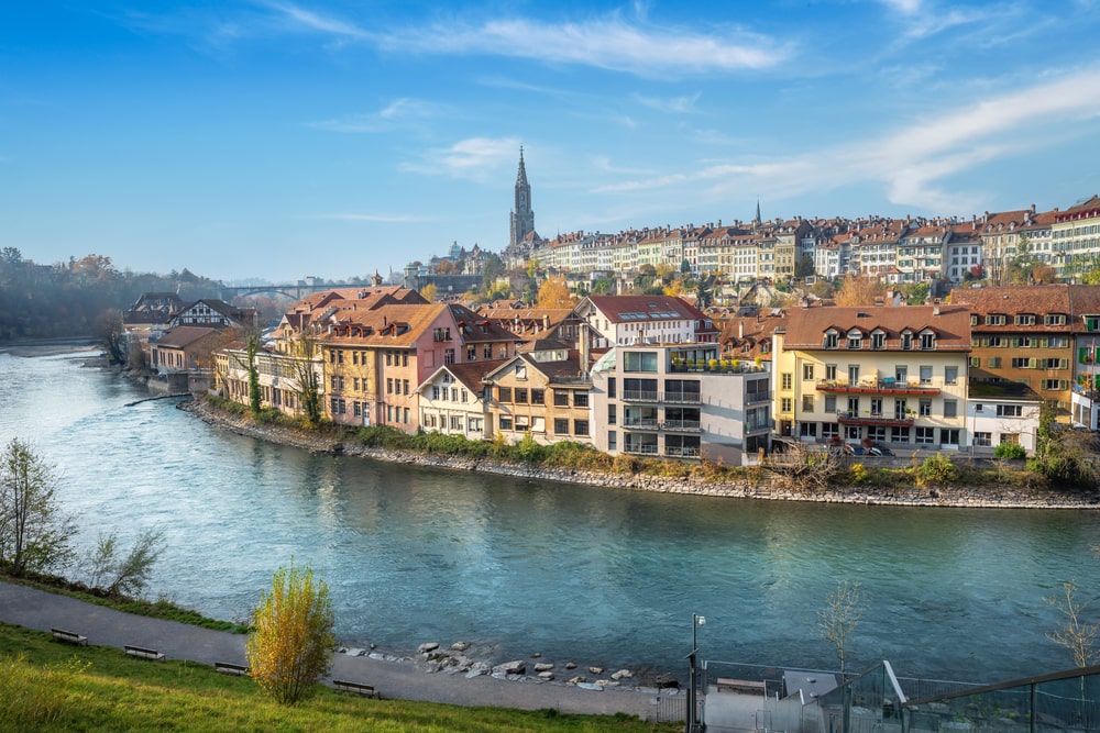 Bern city Skyline with Aare river and Bern Minster Cathedral tower on background - Bern, Switzerland