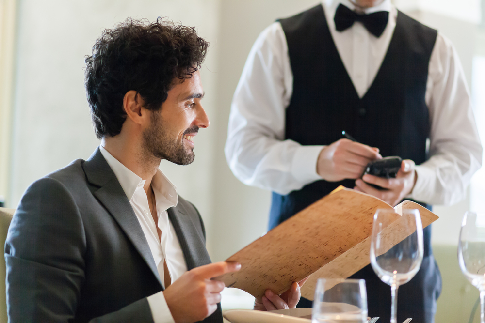 Elegant gekleideter Mann bei einem diskreten Treffen im Restaurant